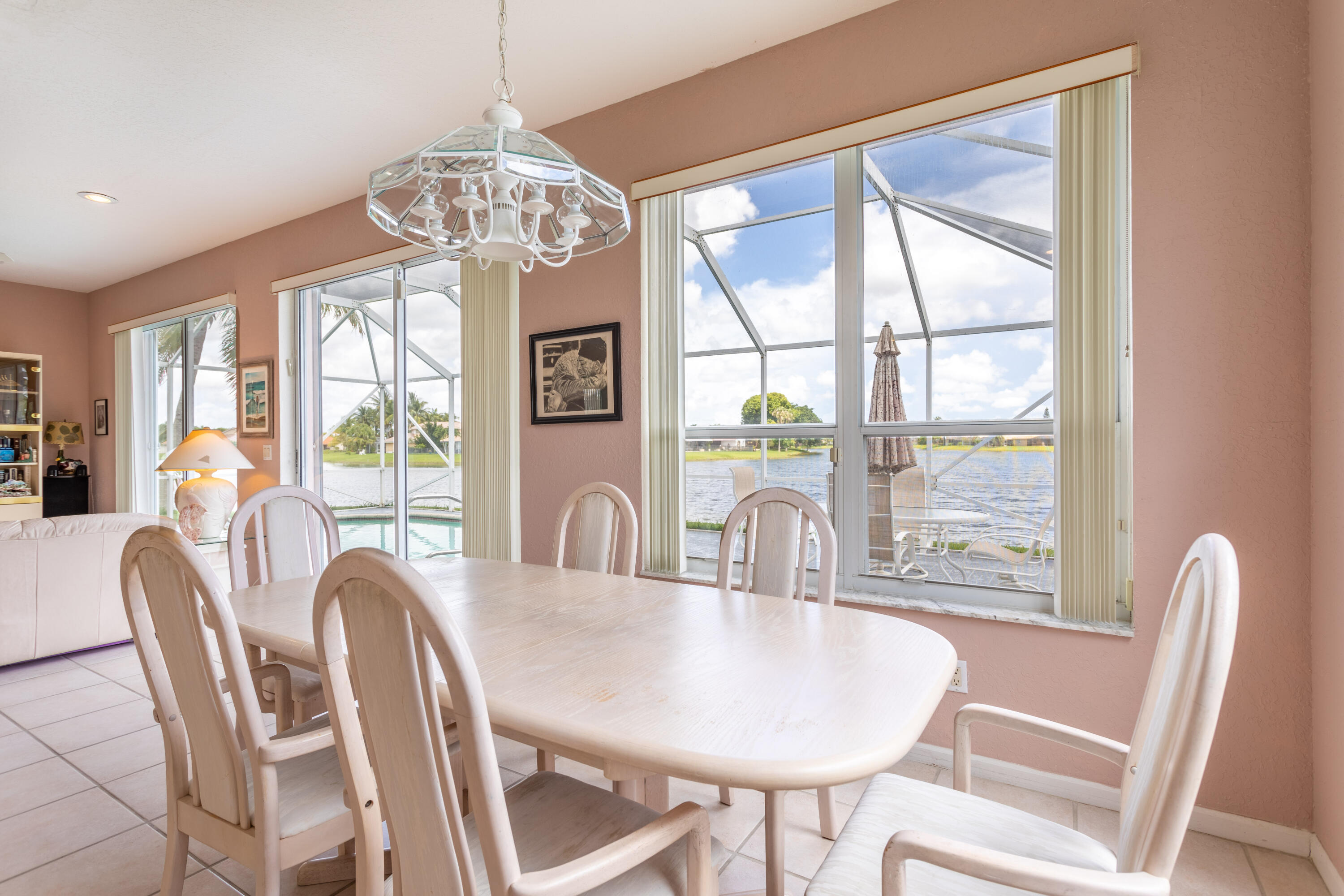12601 Maypan Drive Boca Raton, FL 33428 - Photo 16 of 46 a dining room with furniture a chandelier and wooden floor
