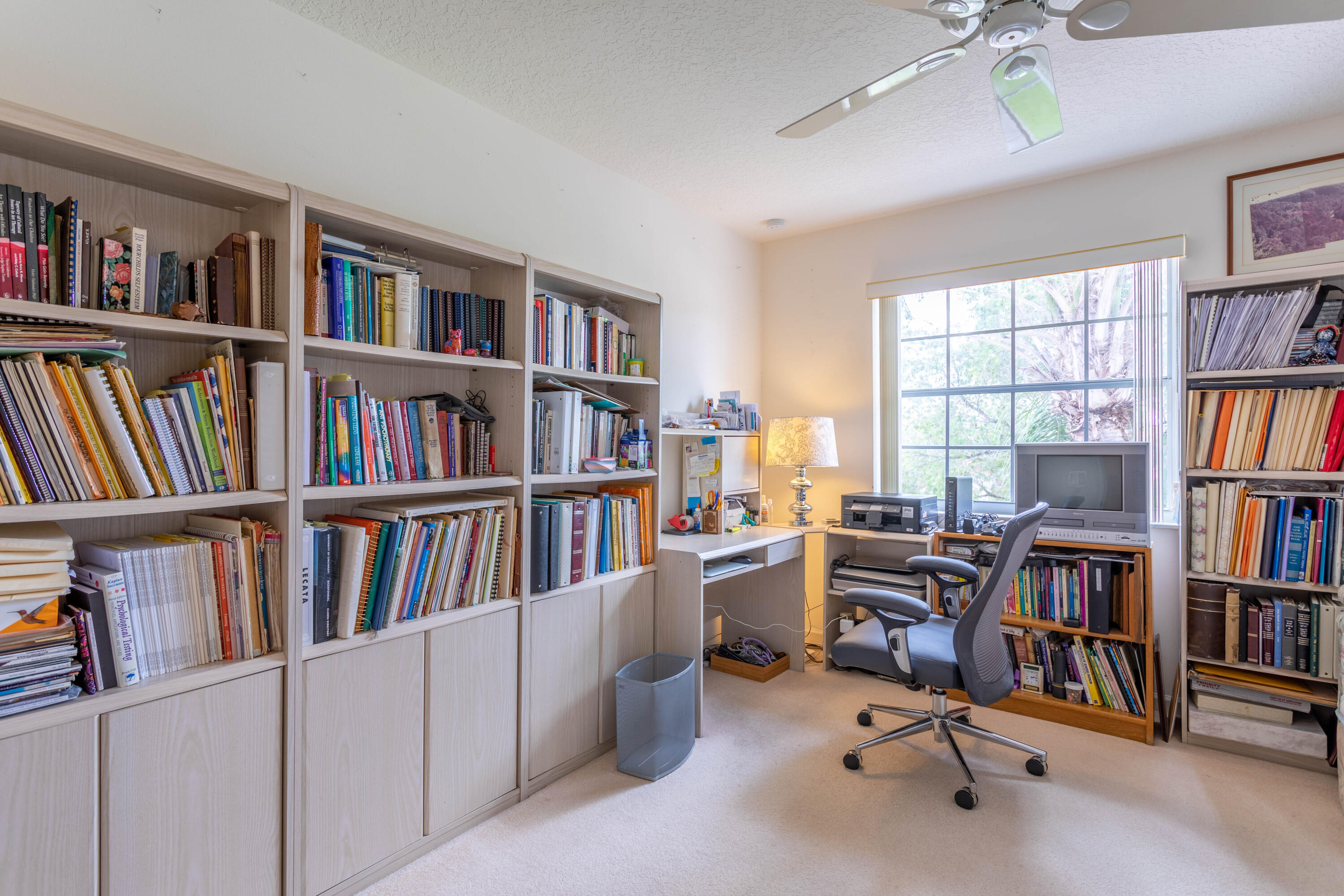 12601 Maypan Drive Boca Raton, FL 33428 - Photo 19 of 46 a view of a workspace with bookshelf and a window