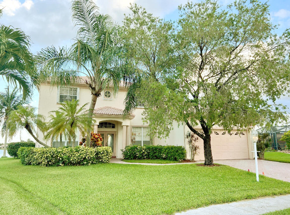 12601 Maypan Drive Boca Raton, FL 33428 - Photo 2 of 46 a front view of a house with a garden