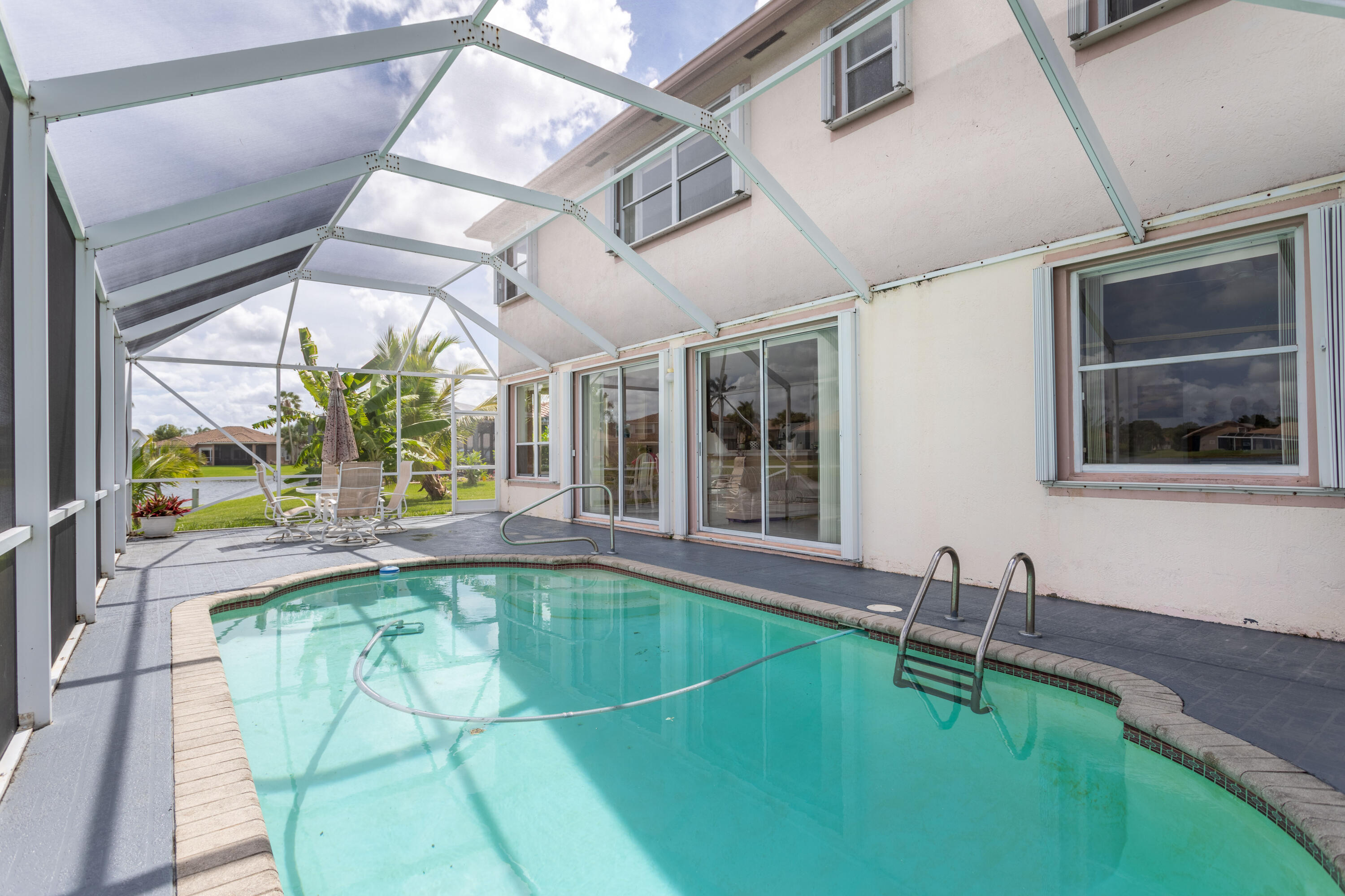12601 Maypan Drive Boca Raton, FL 33428 - Photo 33 of 46 a swimming pool with chair and couch