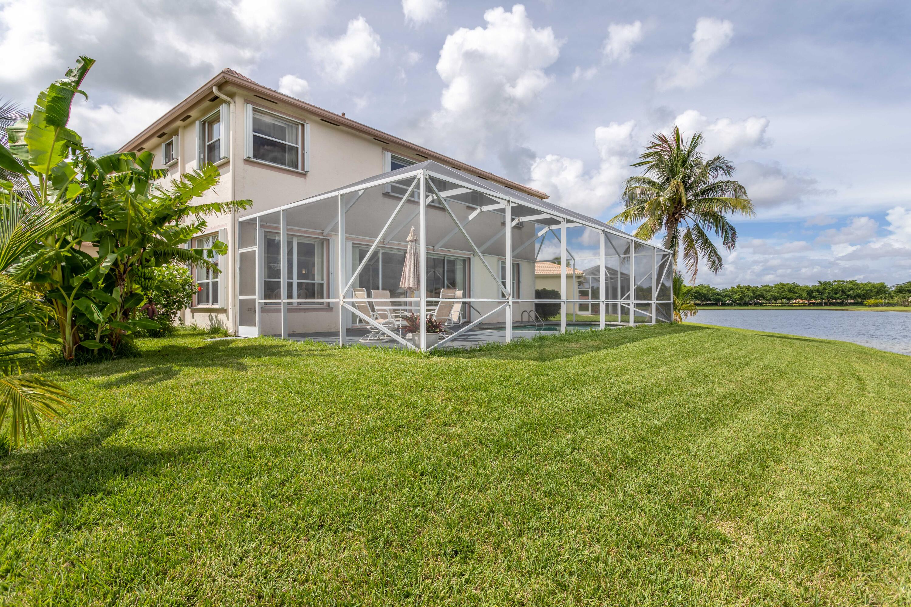 12601 Maypan Drive Boca Raton, FL 33428 - Photo 34 of 46 a front view of a house with a yard