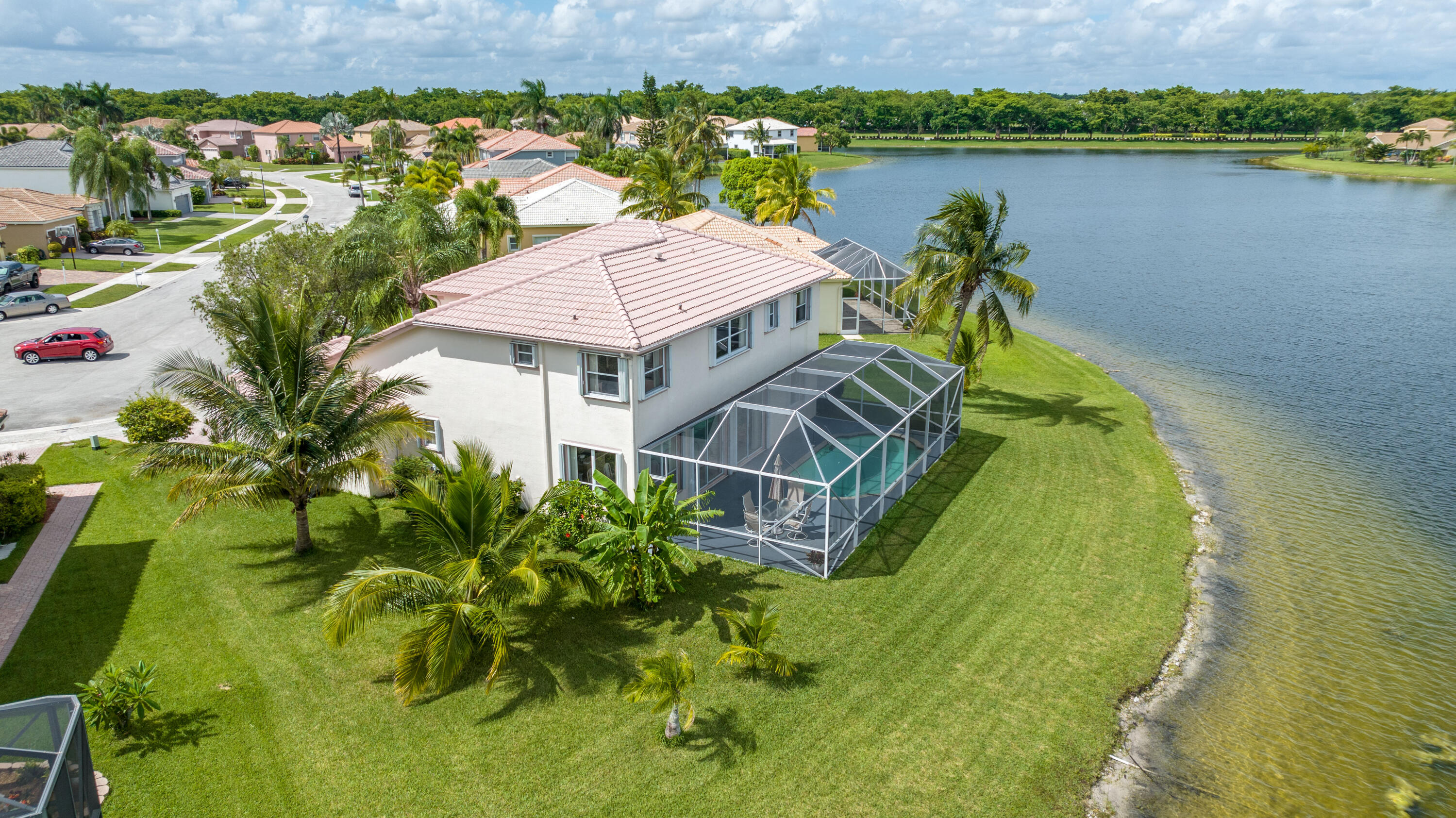 12601 Maypan Drive Boca Raton, FL 33428 - Photo 4 of 46 an aerial view of a house with a yard and lake view