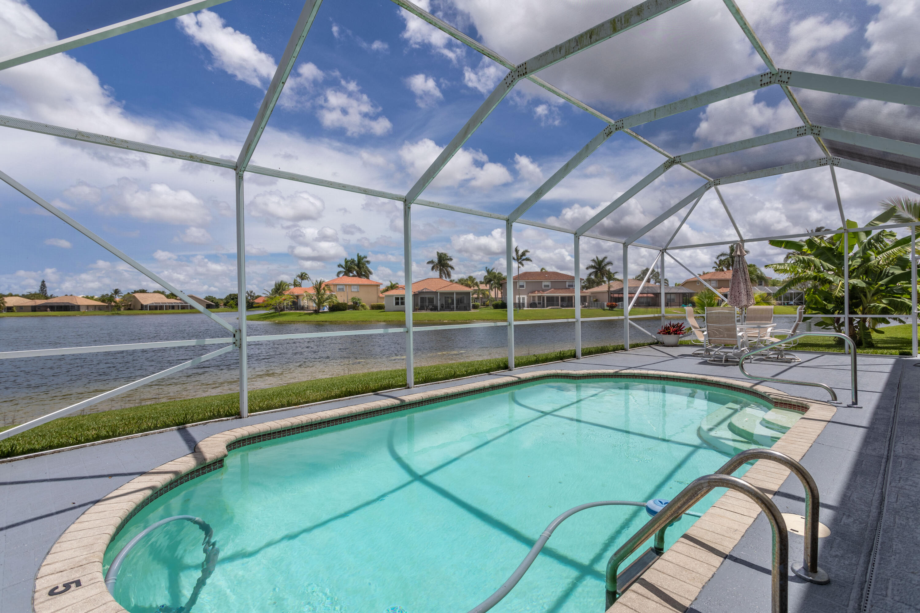 12601 Maypan Drive Boca Raton, FL 33428 - Photo 5 of 46 a view of a swimming pool with a porch