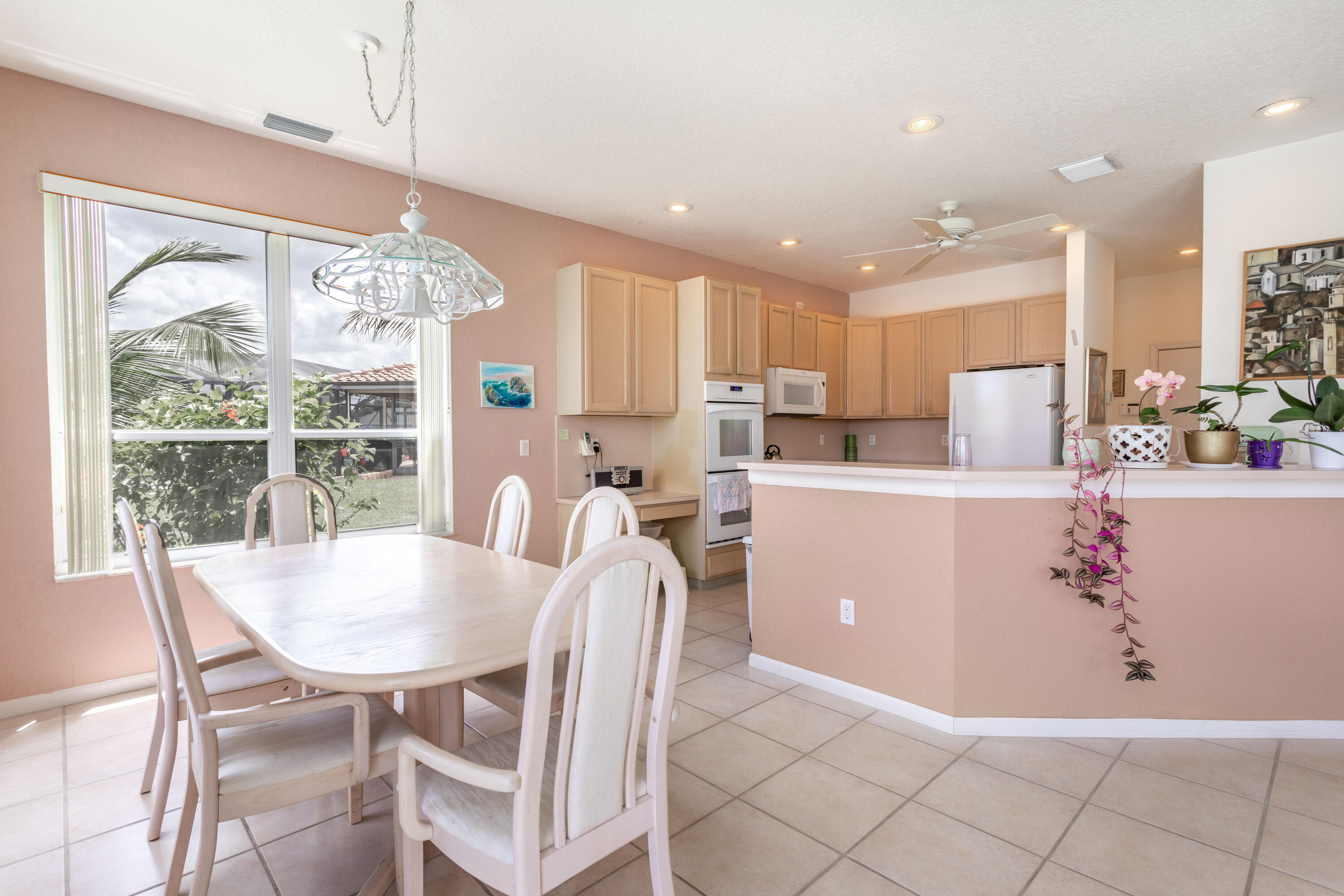 12601 Maypan Drive Boca Raton, FL 33428 - Photo 8 of 46 a living room with kitchen island furniture and a chandelier