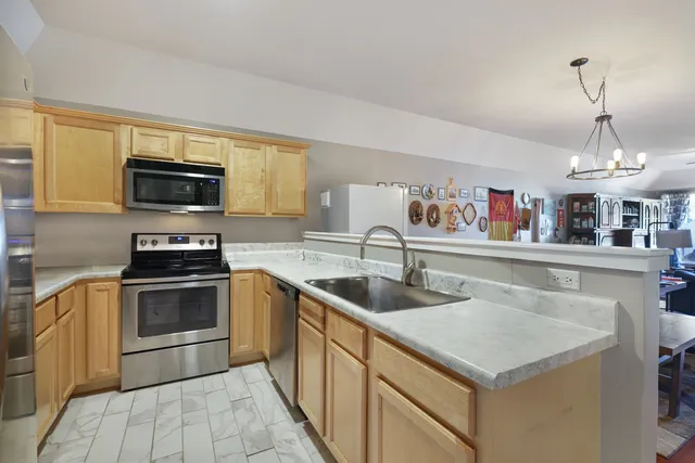 a kitchen with granite countertop a sink and a stove top oven