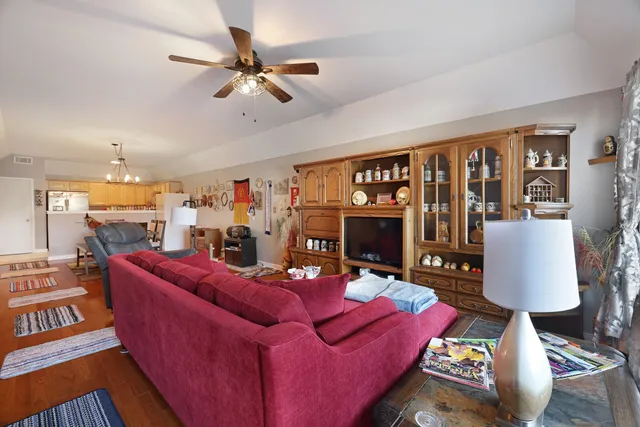 a living room with furniture a fireplace and a large window