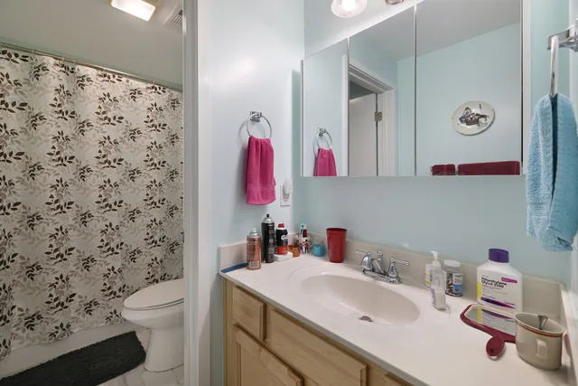 a bathroom with a sink toilet and a mirror