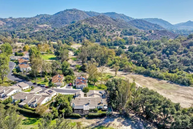 an aerial view of residential houses with outdoor space and street view