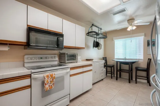 a kitchen with stainless steel appliances granite countertop a sink and a stove