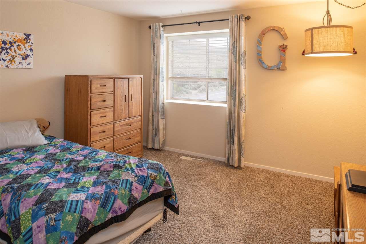 17165 Touraco Street Reno, NV 89508 - Photo 12 of 24 a bedroom with a bed and a dresser