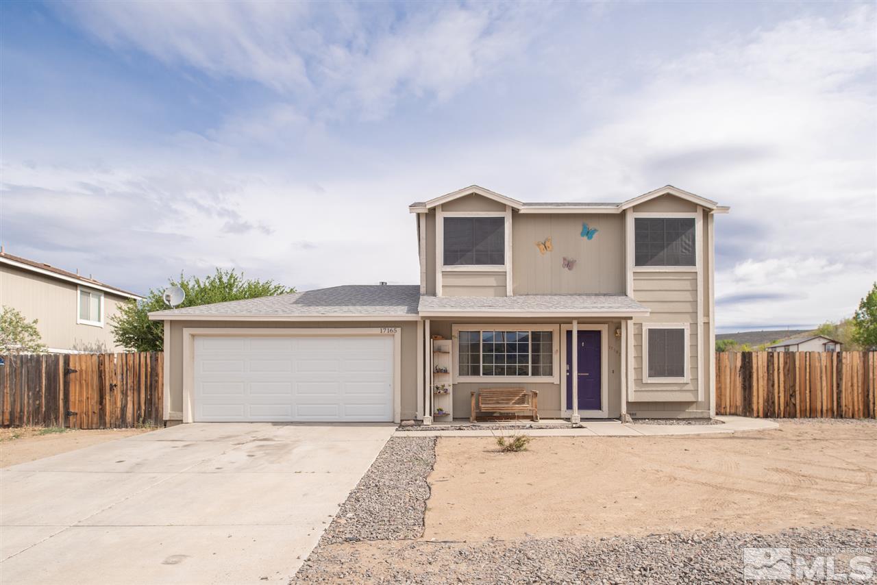 17165 Touraco Street Reno, NV 89508 - Photo 23 of 24 a front view of a house with a yard and garage