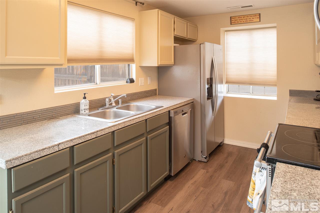 17165 Touraco Street Reno, NV 89508 - Photo 6 of 24 a kitchen with a sink appliances and cabinets