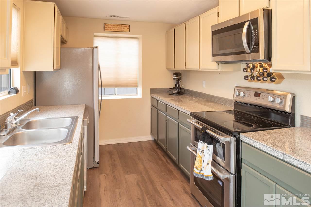 17165 Touraco Street Reno, NV 89508 - Photo 7 of 24 a kitchen that has a sink and a stove