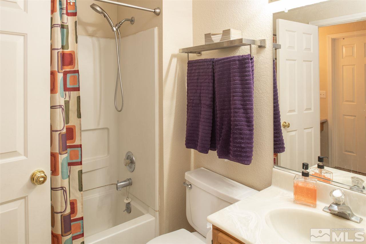 17165 Touraco Street Reno, NV 89508 - Photo 10 of 24 a bathroom with a bathtub and a sink