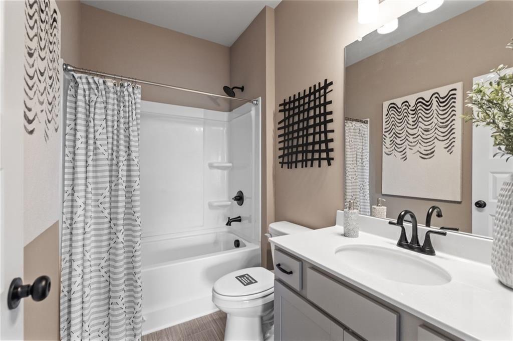 310 Caroline Place, Unit 100 Villa Rica, GA 30180 - Photo 18 of 30 a bathroom with a sink toilet vanity and shower