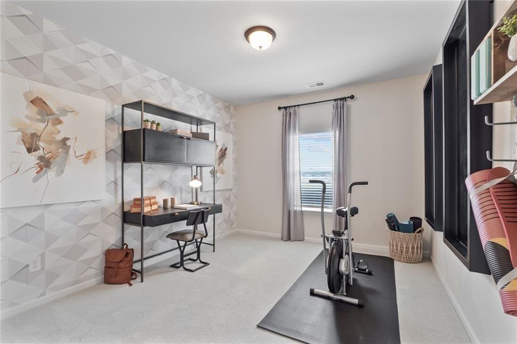 310 Caroline Place, Unit 100 Villa Rica, GA 30180 - Photo 19 of 30 a room with gym equipment and a table