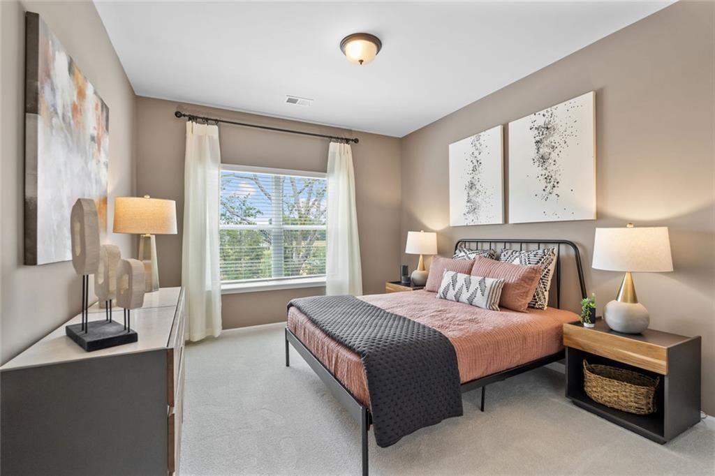 310 Caroline Place, Unit 100 Villa Rica, GA 30180 - Photo 21 of 30 a bedroom with a bed and a night stand