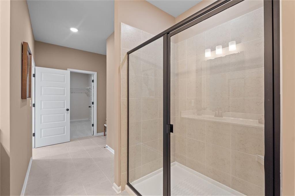 310 Caroline Place, Unit 100 Villa Rica, GA 30180 - Photo 24 of 30 a bathroom with a glass shower door