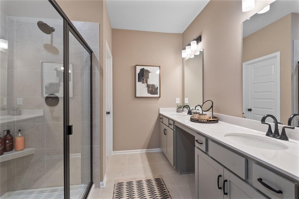 310 Caroline Place, Unit 100 Villa Rica, GA 30180 - Photo 25 of 30 a bathroom with a sink a toilet and shower