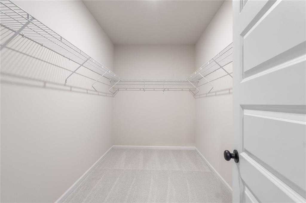 310 Caroline Place, Unit 100 Villa Rica, GA 30180 - Photo 27 of 30 a view of a room with racks on the wall