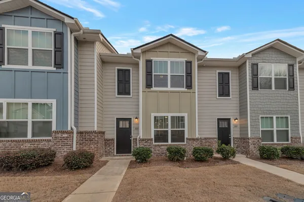 a front view of a house with garden