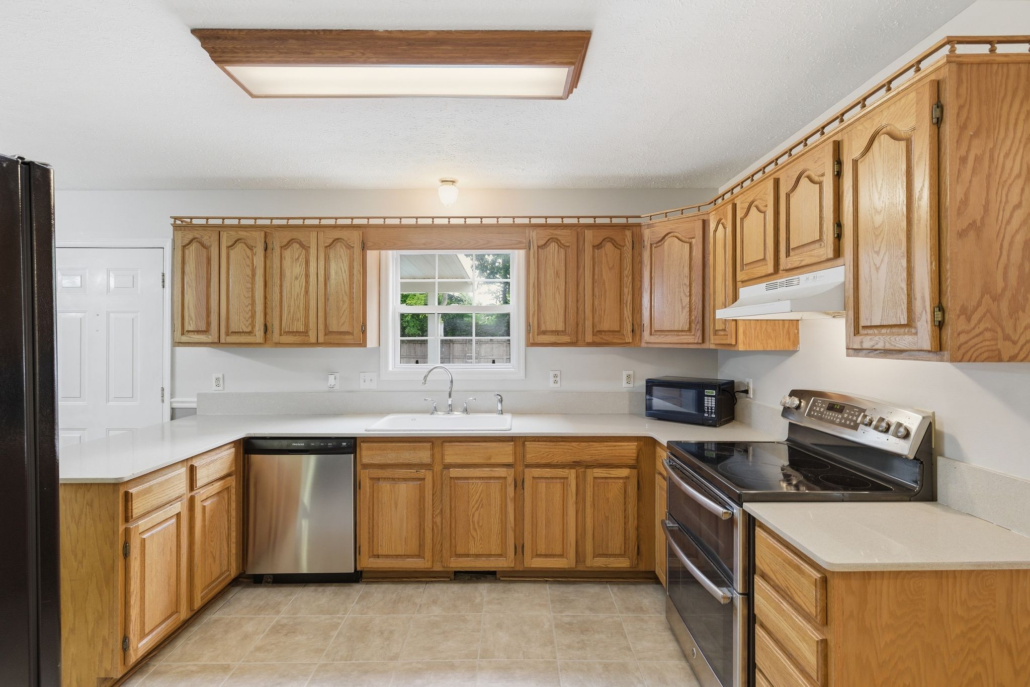 615 Vaughan's Gap Road Spring Hill, TN 37174 - Photo 8 of 26 a kitchen with a sink stove top oven and cabinets