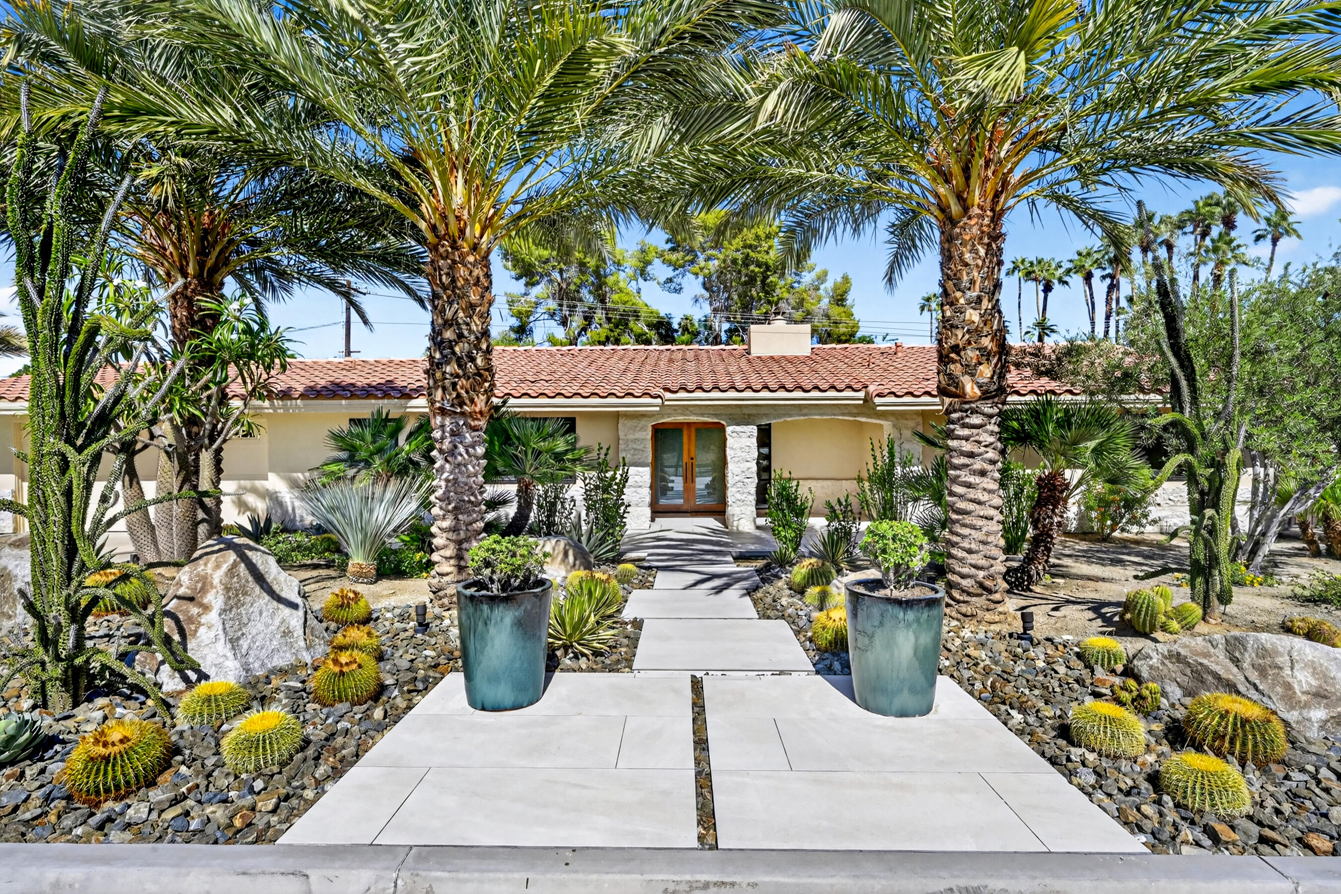 74090 Setting Sun Trail Palm Desert, CA 92260 - Photo 1 of 46 a view of a patio with table and chairs potted plants