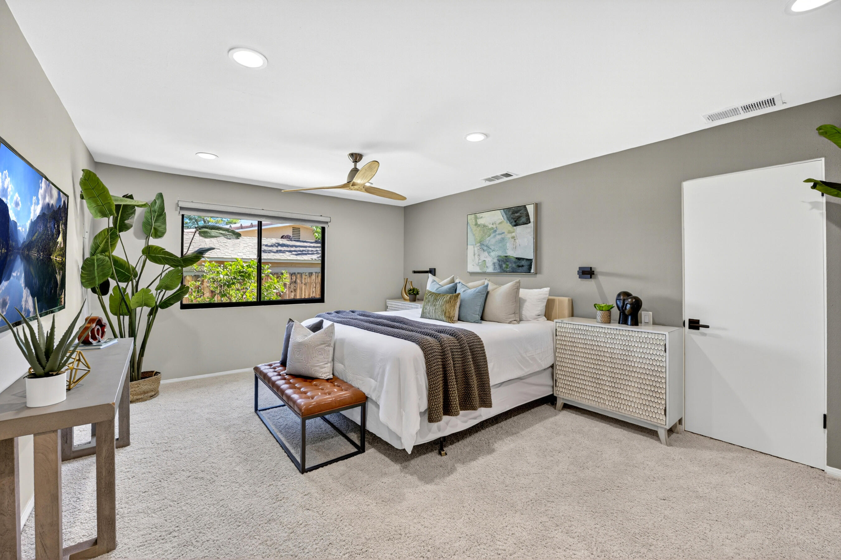 74090 Setting Sun Trail Palm Desert, CA 92260 - Photo 13 of 46 a spacious bedroom with a bed and a couch