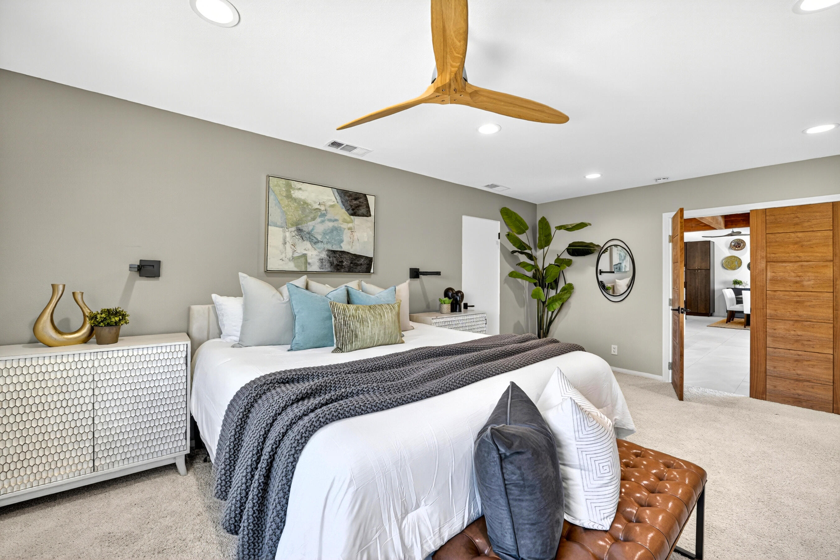 74090 Setting Sun Trail Palm Desert, CA 92260 - Photo 15 of 46 a bedroom with a bed and a chandelier