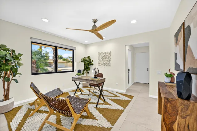 a view of a livingroom with furniture and a window