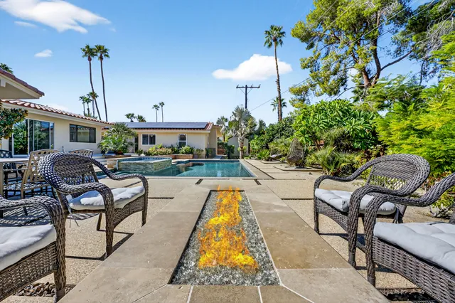 a front view of house with yard outdoor seating and potted plants