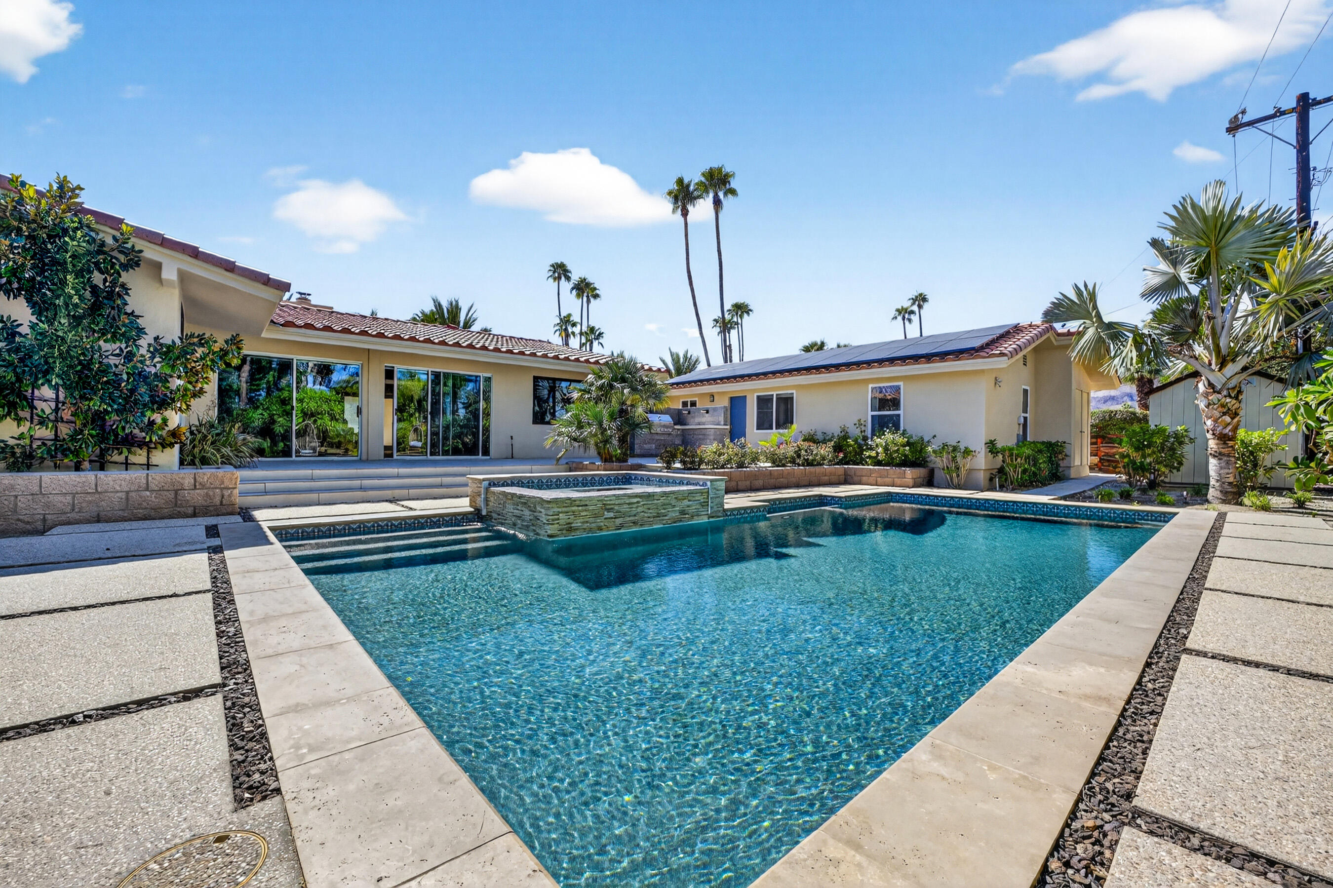 74090 Setting Sun Trail Palm Desert, CA 92260 - Photo 29 of 46 a view of a swimming pool with a patio