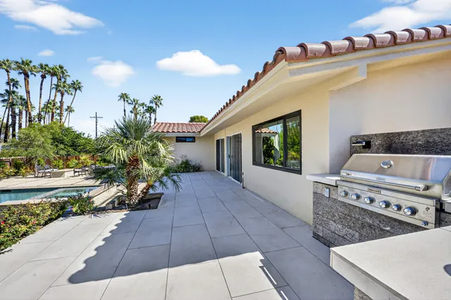 a kitchen with stainless steel appliances granite countertop a stove and a sink