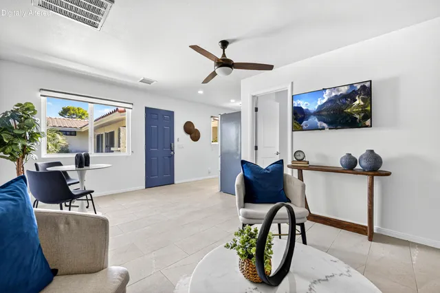 a bathroom with a granite countertop sink mirror and toilet