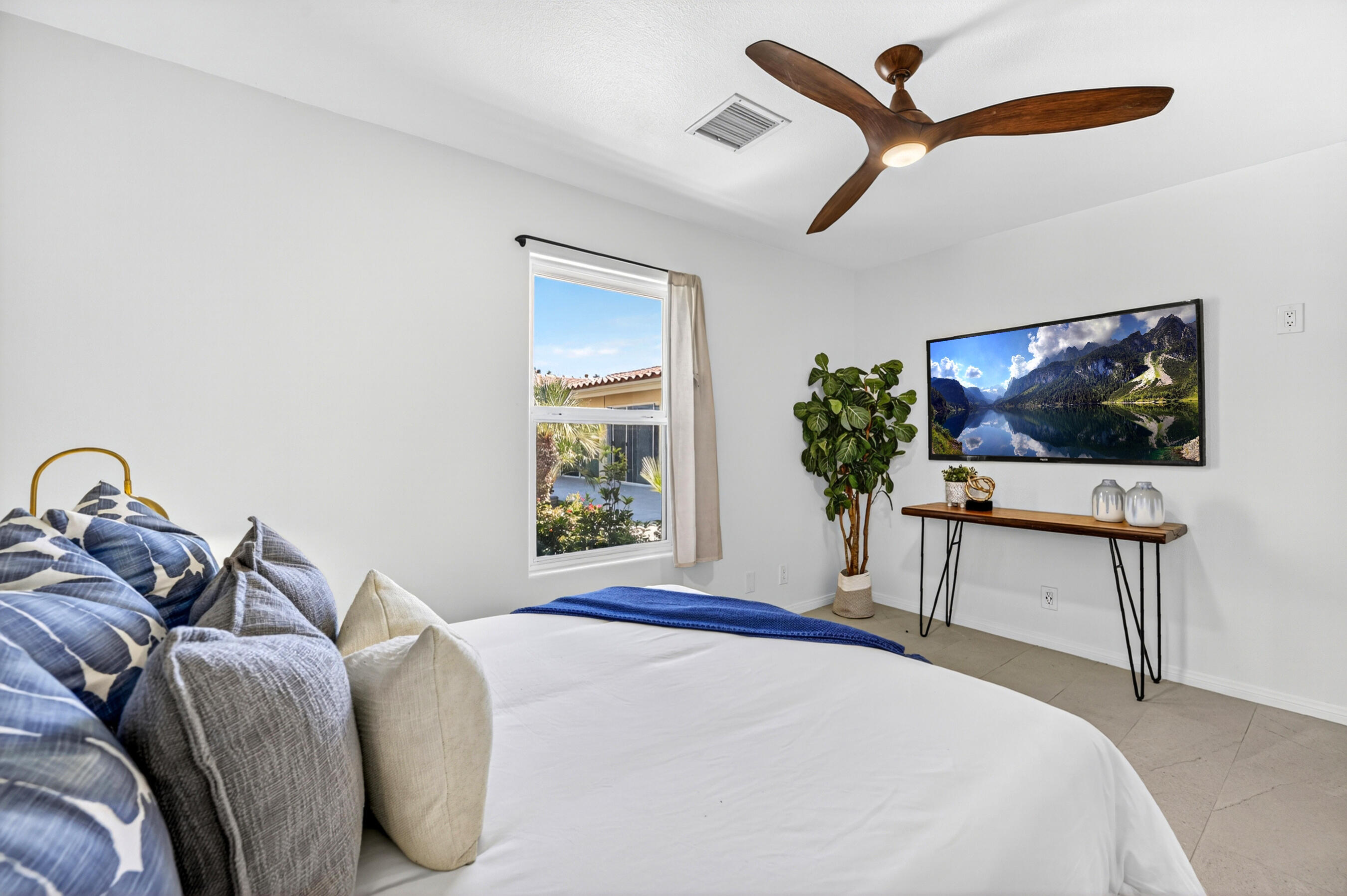 74090 Setting Sun Trail Palm Desert, CA 92260 - Photo 38 of 46 a bedroom with a bed and a flat screen tv