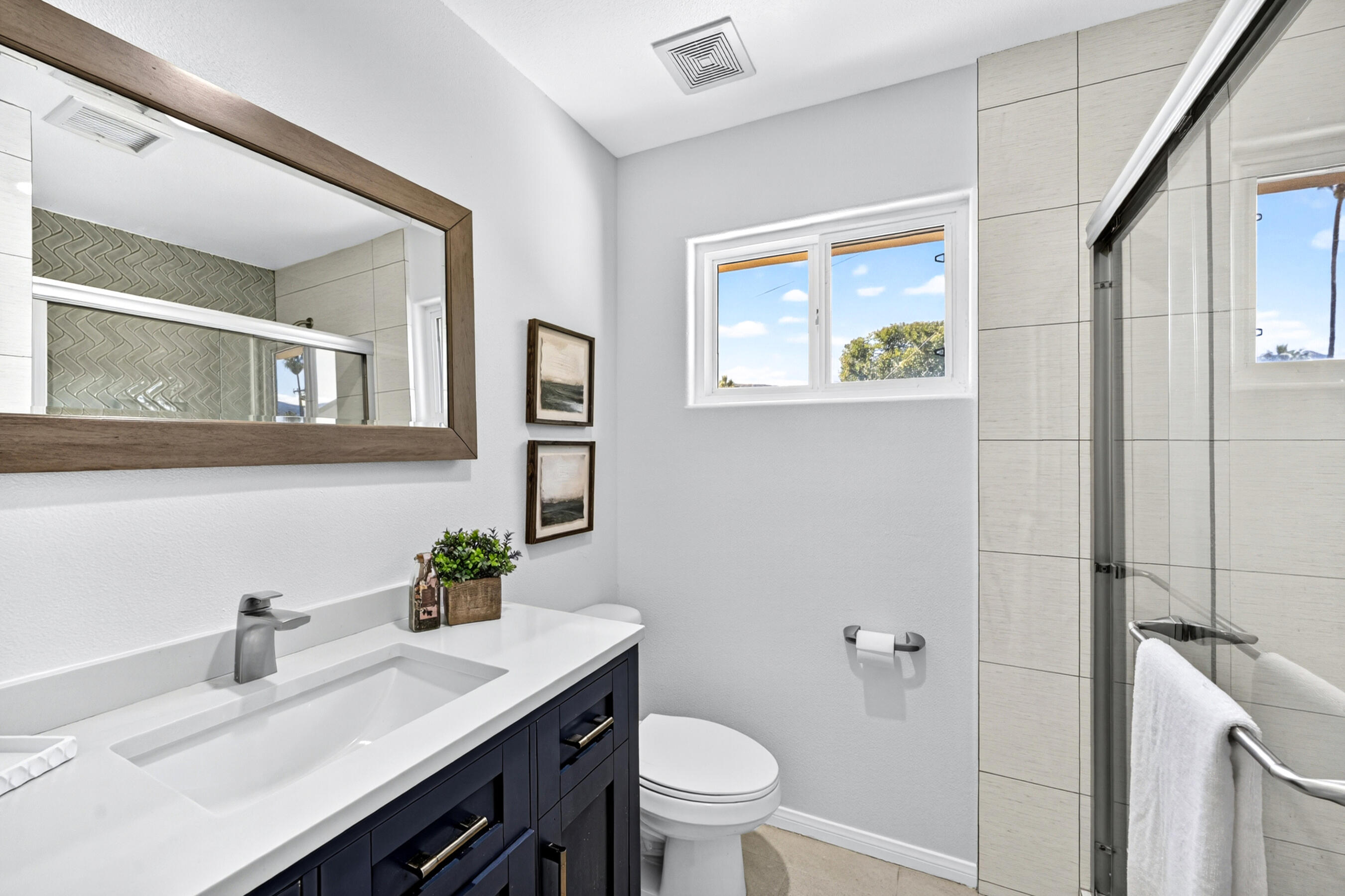 74090 Setting Sun Trail Palm Desert, CA 92260 - Photo 39 of 46 a bathroom with a granite countertop sink mirror and toilet
