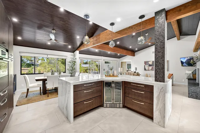 a large kitchen with stainless steel appliances granite countertop a large counter top space a sink stainless steel appliances and cabinets