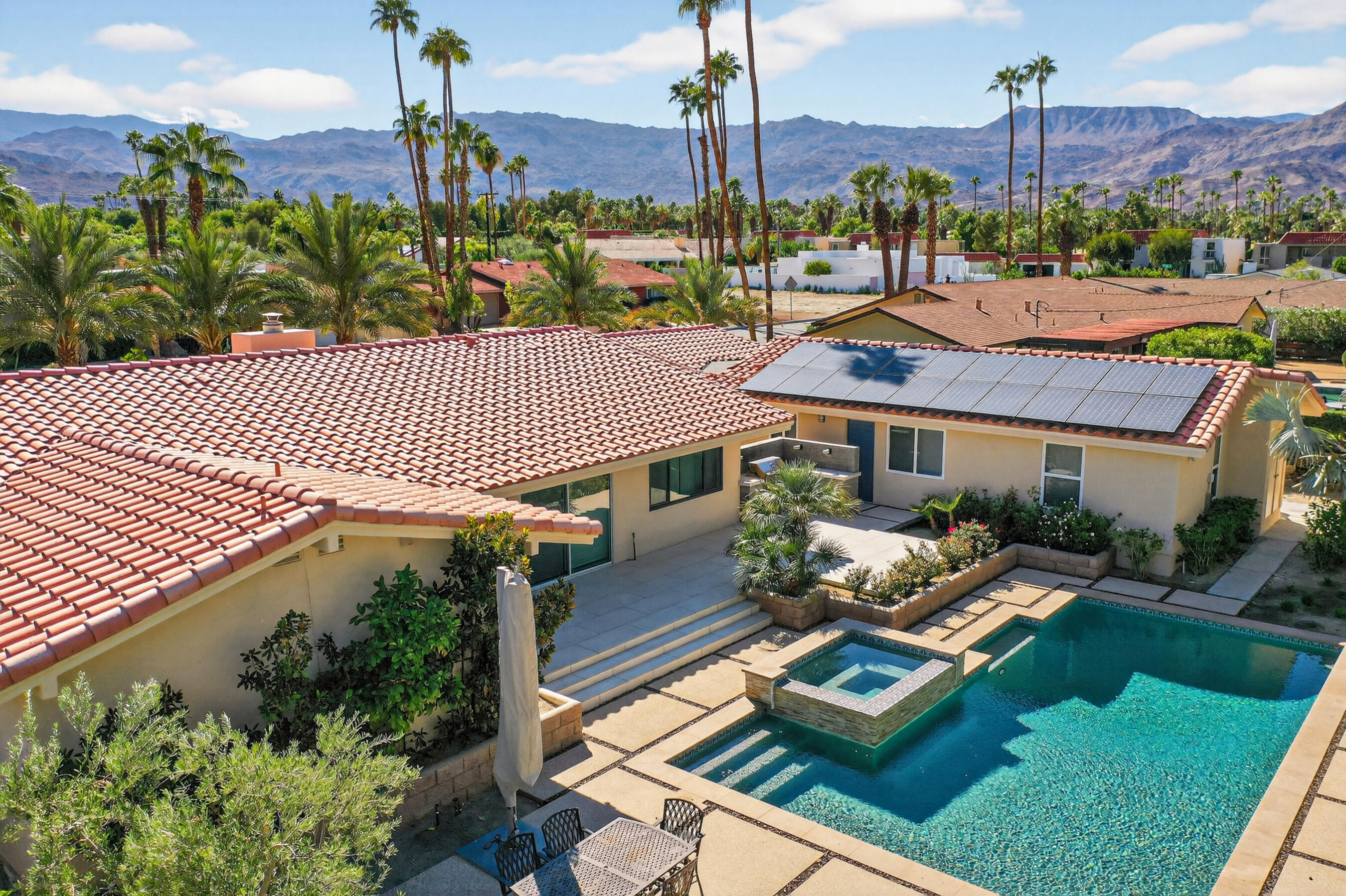 74090 Setting Sun Trail Palm Desert, CA 92260 - Photo 45 of 46 a front view of a house with a garden and trees