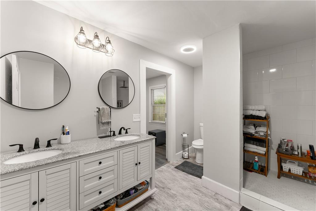 5907 Main Street Lula, GA 30554 - Photo 32 of 60 a spacious bathroom with a double vanity sink and a mirror