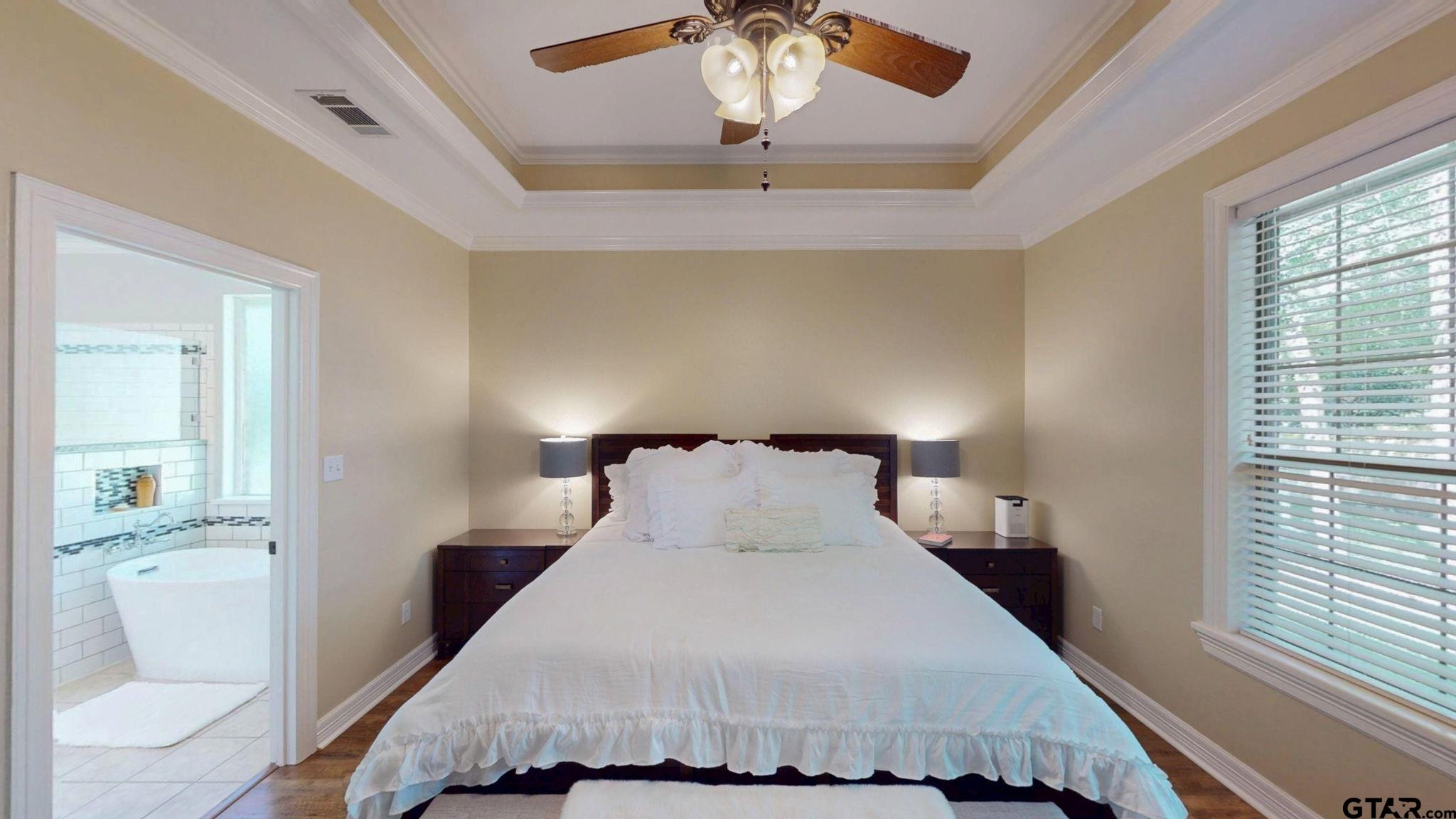 18488 Bluebird Circle Flint, TX 75762 - Photo 22 of 47 a bedroom with a bed and a chandelier