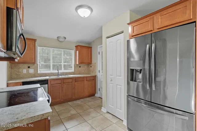 a kitchen with stainless steel appliances granite countertop a stove microwave and sink