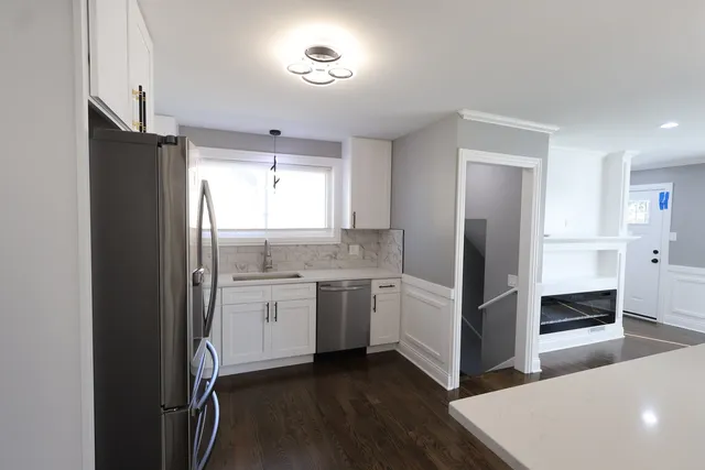 a kitchen with a refrigerator and a sink