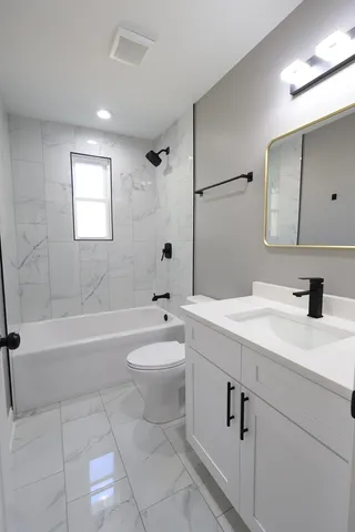 a bathroom with a sink a toilet and bathtub