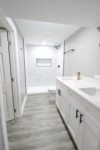 a spacious bathroom with a double vanity sink and a mirror