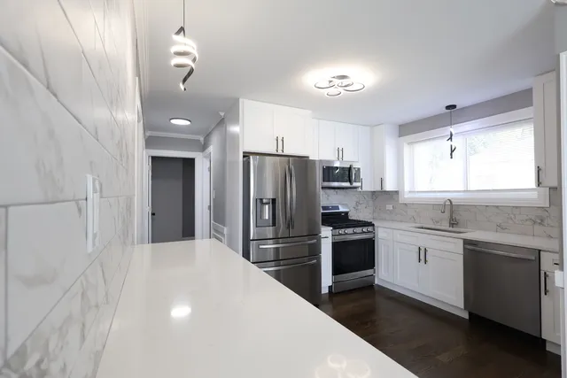 a kitchen with a sink stainless steel appliances and cabinets