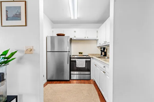 a kitchen with stainless steel appliances granite countertop a refrigerator sink and cabinets