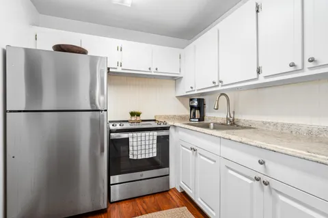 a living room with furniture window and refrigerator