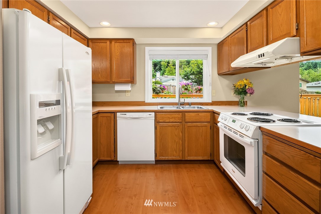 23423 9th Place West Bothell, WA 98021 - Photo 11 of 26 a kitchen with stainless steel appliances a stove a sink and a refrigerator