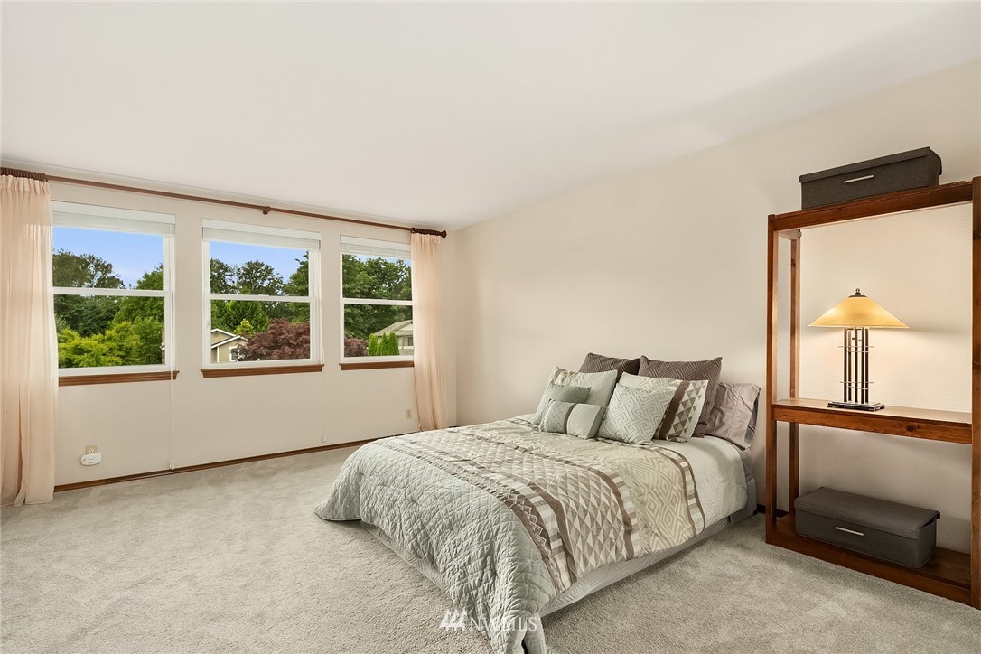 23423 9th Place West Bothell, WA 98021 - Photo 16 of 26 a bedroom with a bed and window with lamp