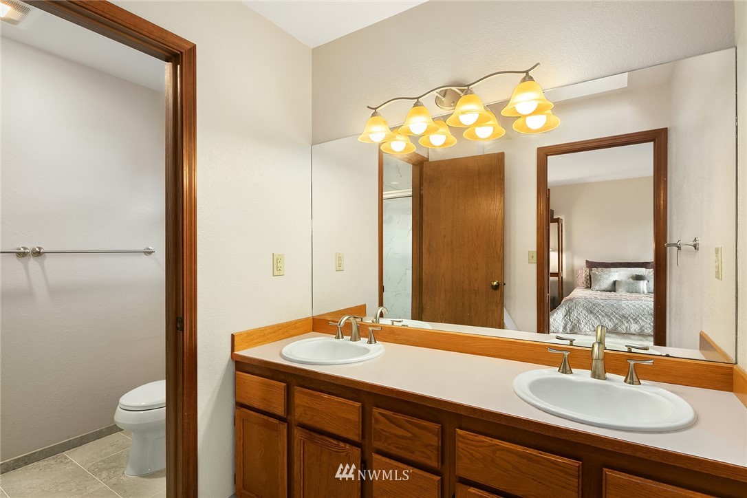 23423 9th Place West Bothell, WA 98021 - Photo 17 of 26 a bathroom with a sink a toilet and a mirror